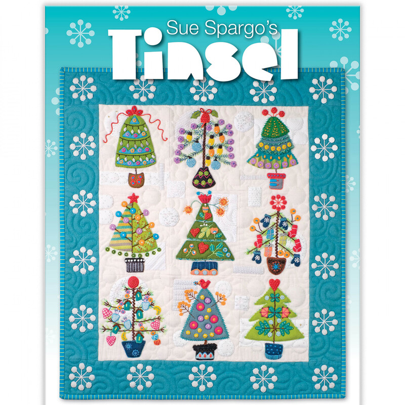Front cover of the Tinsel pattern book, a bright aqua quilt with a white center and nine blocks of heavily detailed and embellished wool Christmas trees.
