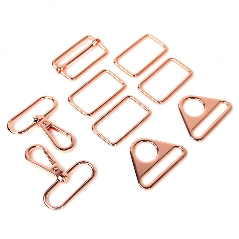 Rose gold rectangle rings, swivel hooks, triangle rings, and a slider buckle, all isolated on a white background.