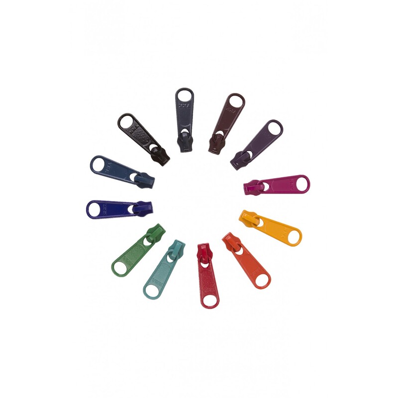 The 12 dark zipper pulls, arranged in a circle and isolated on a white background.