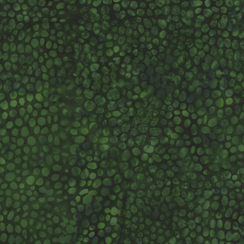 Deep green mottled batik fabric with small mottled green circles all over making a scale-like appearance