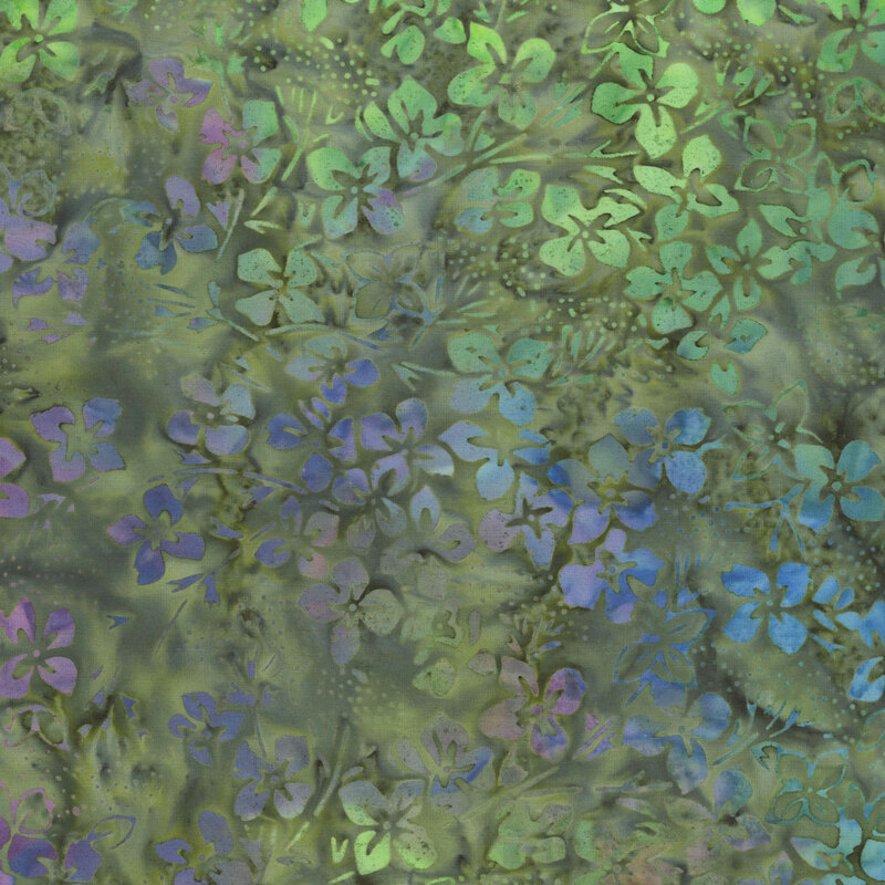 Mottled green batik fabric with small floral designs that transition from purple, to blue, to green throughout
