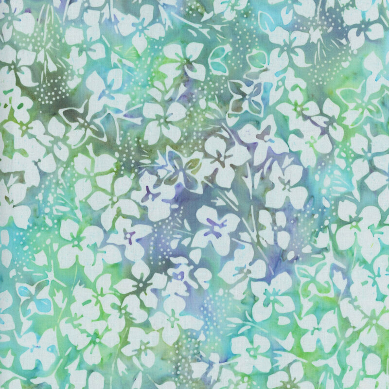 Mottled green and blue batik fabric with white florals all over