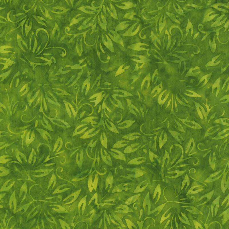 Dark green tonal batik fabric with mottling and light green leaves throughout