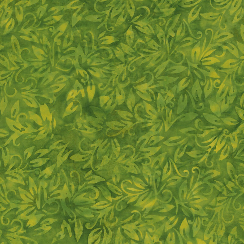 Dark green batik fabric with mottling and light green leaves throughout