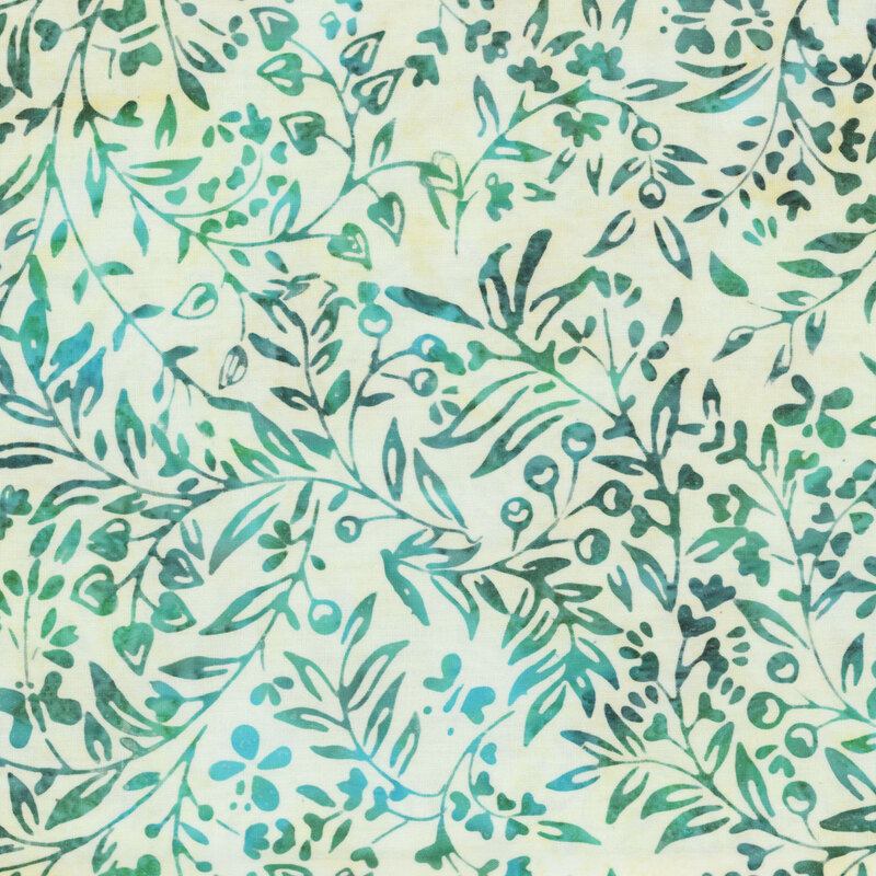 Off white mottled batik fabric with dark green and aqua leaves and vines throughout