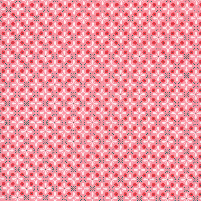Scan of a pink fabric with white, red, and blue flowers all over.