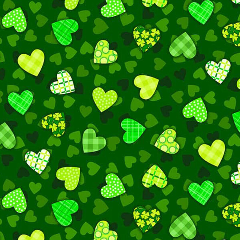 Dark green fabric with mini green and black hearts tossed with larger hearts filled with a design