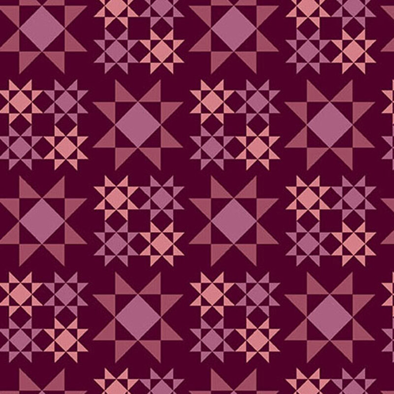 plum fabric with large dark pink and purple Sawtooth Star quilt block patterns scattered across the fabric with smaller versions in purple and pink are arranged in a square formation between the larger ones