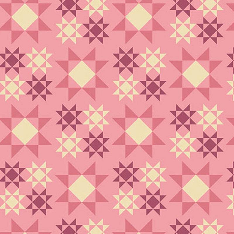 pink fabric with large dark pink and white Sawtooth Star quilt block patterns scattered across the fabric with smaller versions in purple and white are arranged in a square formation between the larger ones