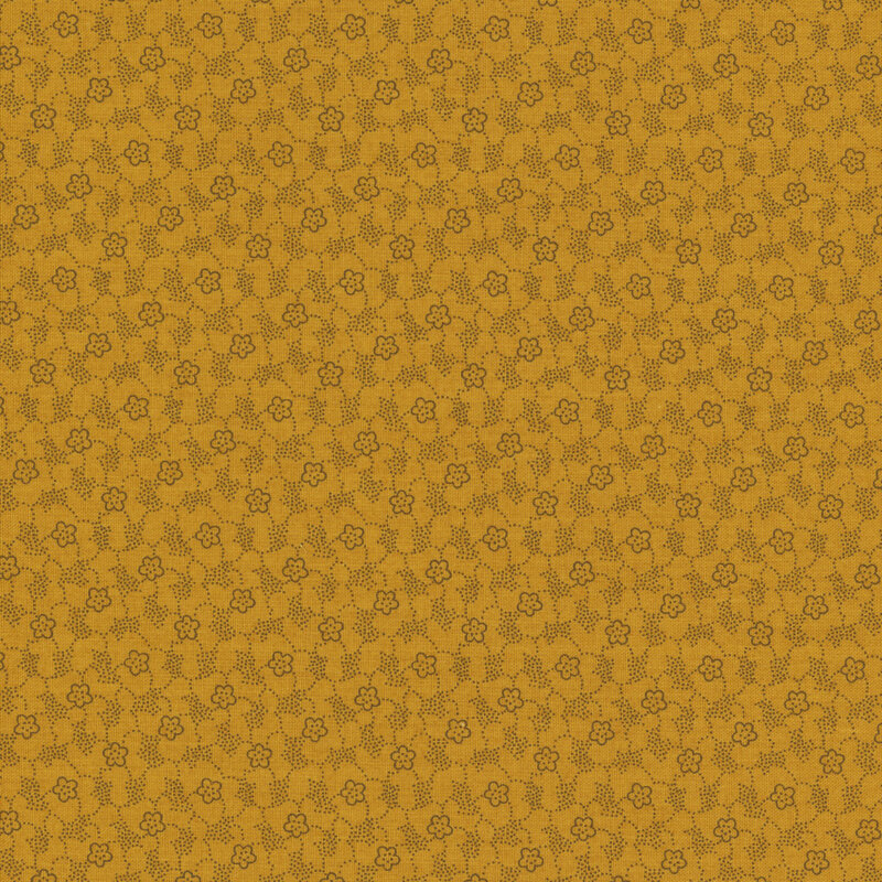 Mustard yellow tonal fabric featuring a textured pattern of tiny dots and flowers