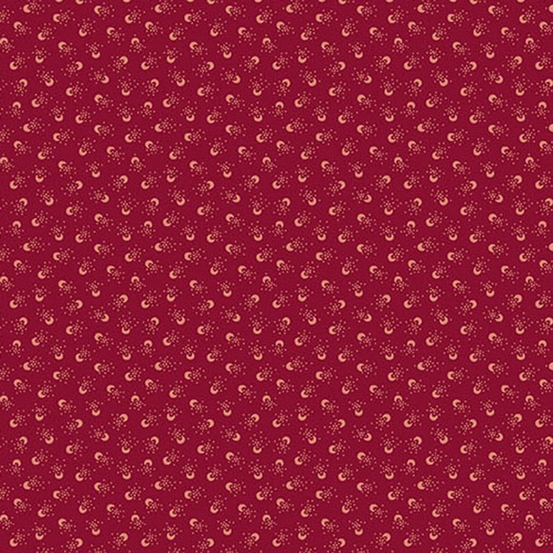 Burgundy red fabric featuring crescent circles surrounded by dots