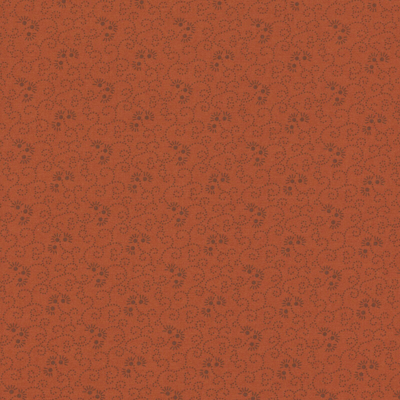 Tonal burnt orange fabric featuring a swirled design with florals