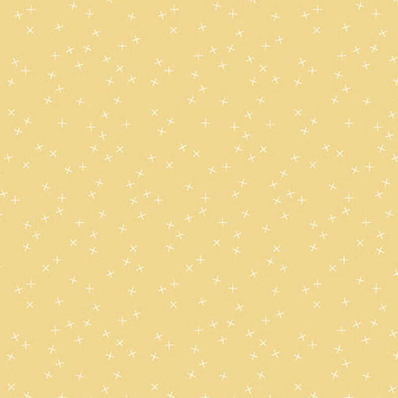 Medium pale yellow fabric with small white X's scattered throughout