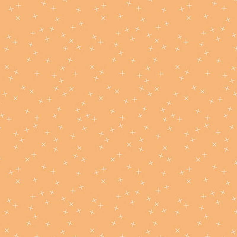 Medium peach fabric with small white X's scattered throughout