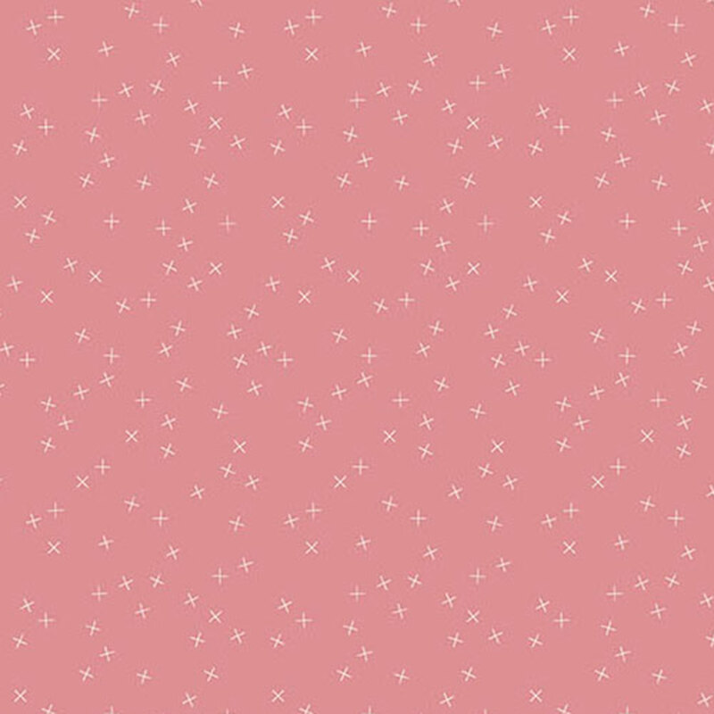 Pale pink fabric with small white X's scattered throughout