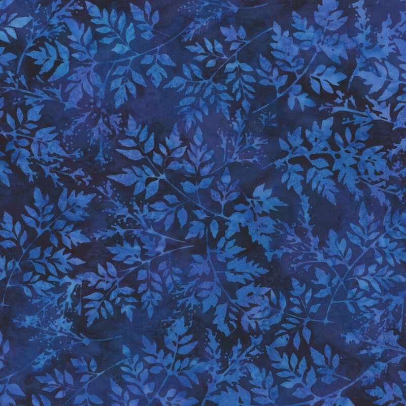 Mottled cobalt blue batik fabric with sprawling leafy branches.