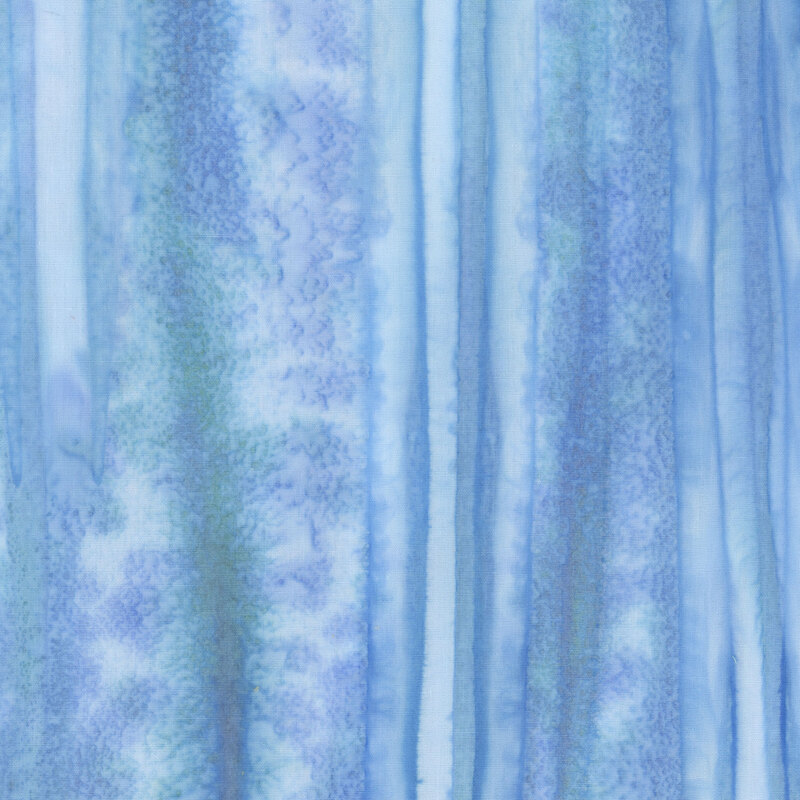 Striped blue batik fabric with interspersed green tones.