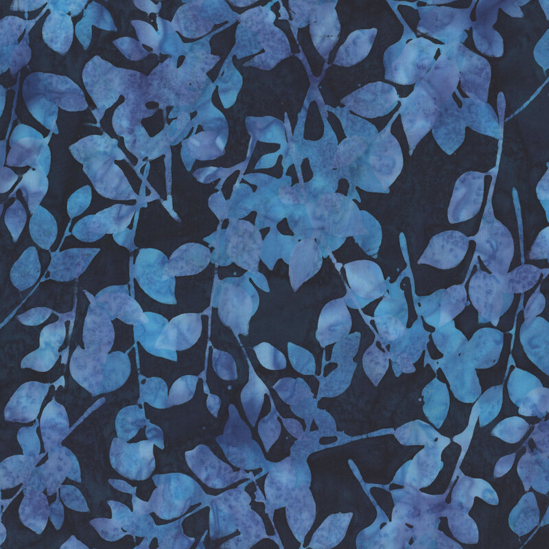 Deep midnight blue mottled batik fabric with outlines of leaves running across the fabric.
