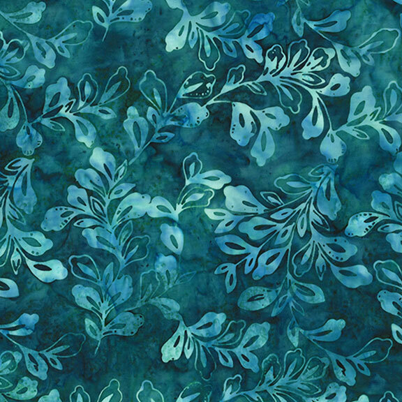 Mottled batik fabric with pale green and aqua leaves and sprigs tossed on a teal background