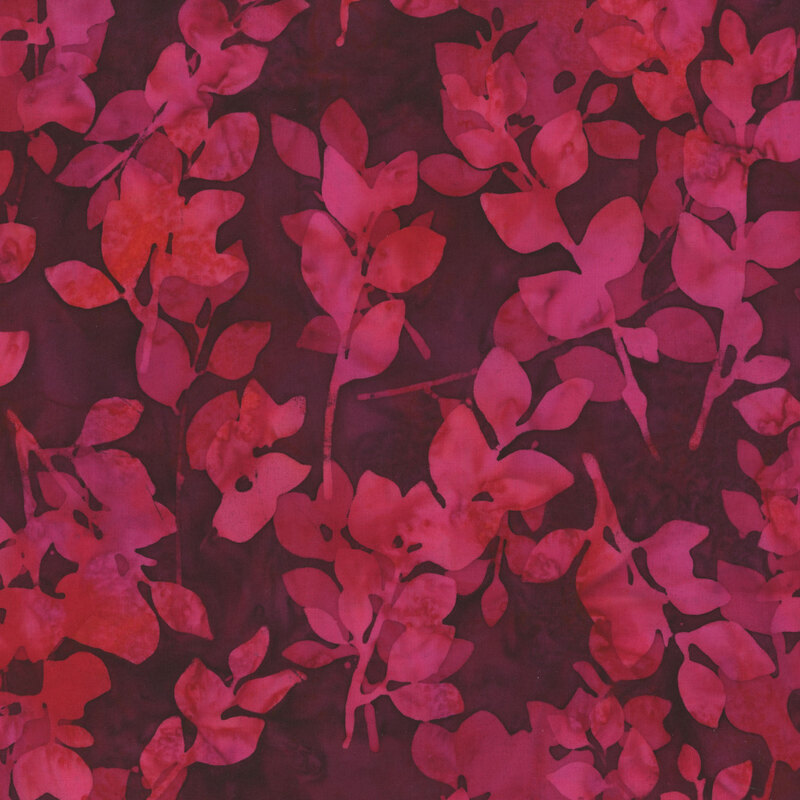 Dark pink mottled batik fabric with bright pink leaves and sprigs throughout.