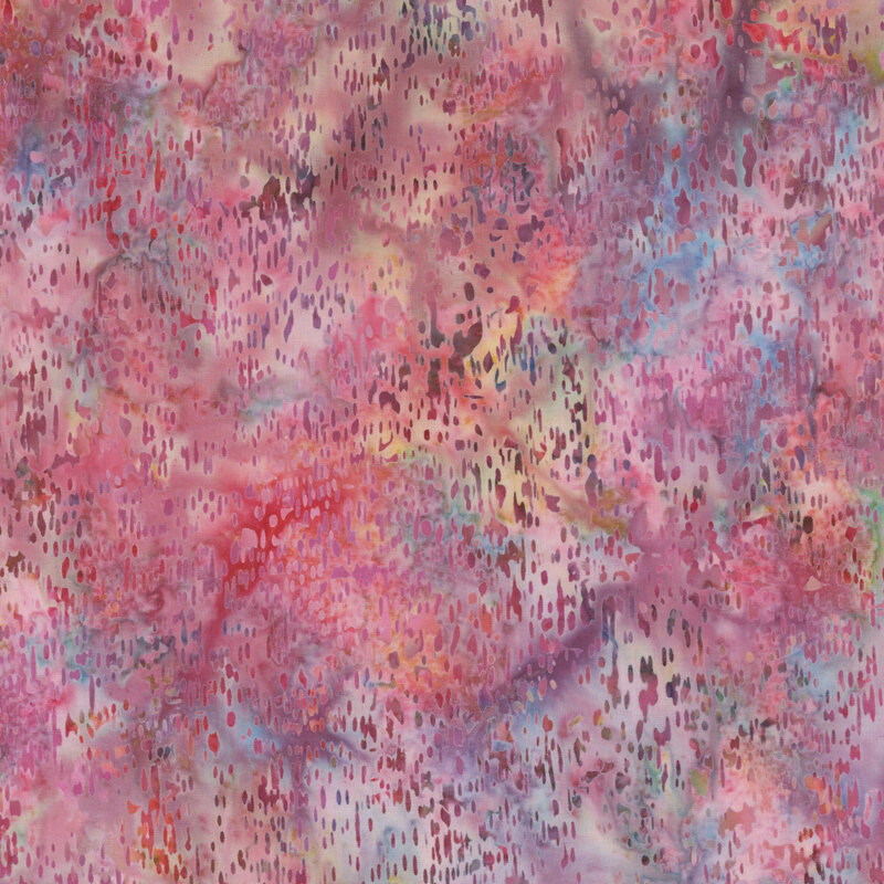 Batik fabric with small textured splotches and a multi-colored mottled background.
