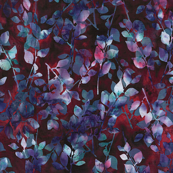 Dark red batik fabric with mottled blue, purple, and aqua leaves and sprigs throughout