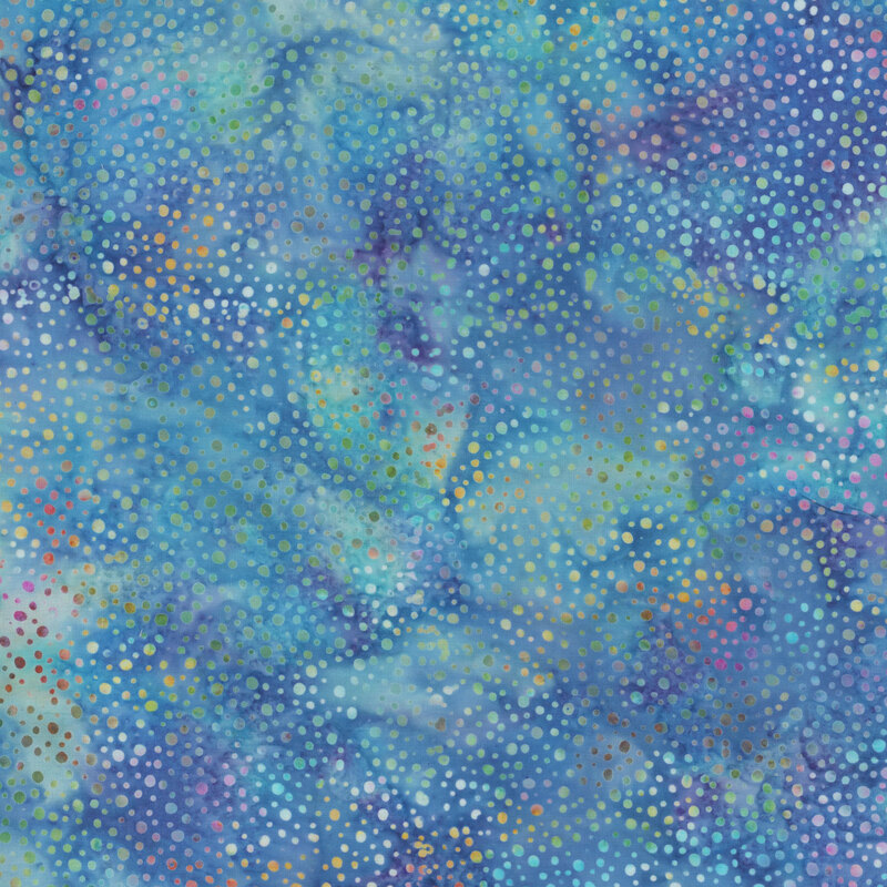 Medium blue batik fabric with purple and aqua mottling throughout and small colorful spots all over.