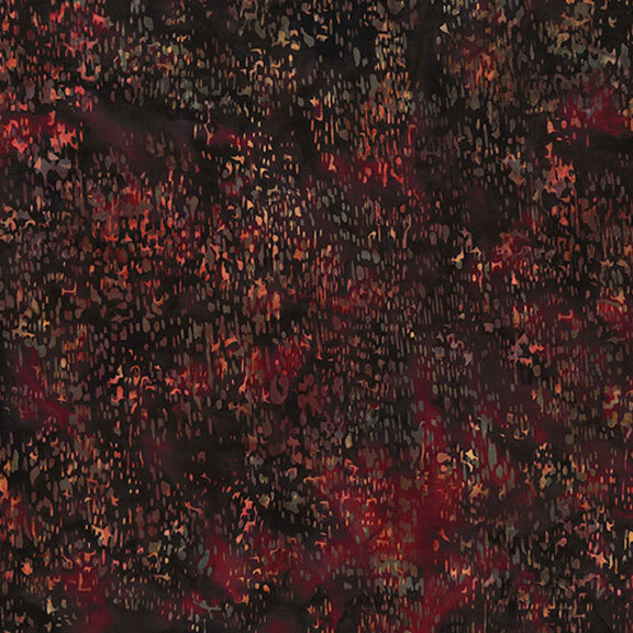 Red batik fabric with a speckled pattern.