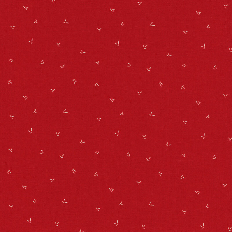 fabric featuring ditsy cream sprinkles on a solid red background