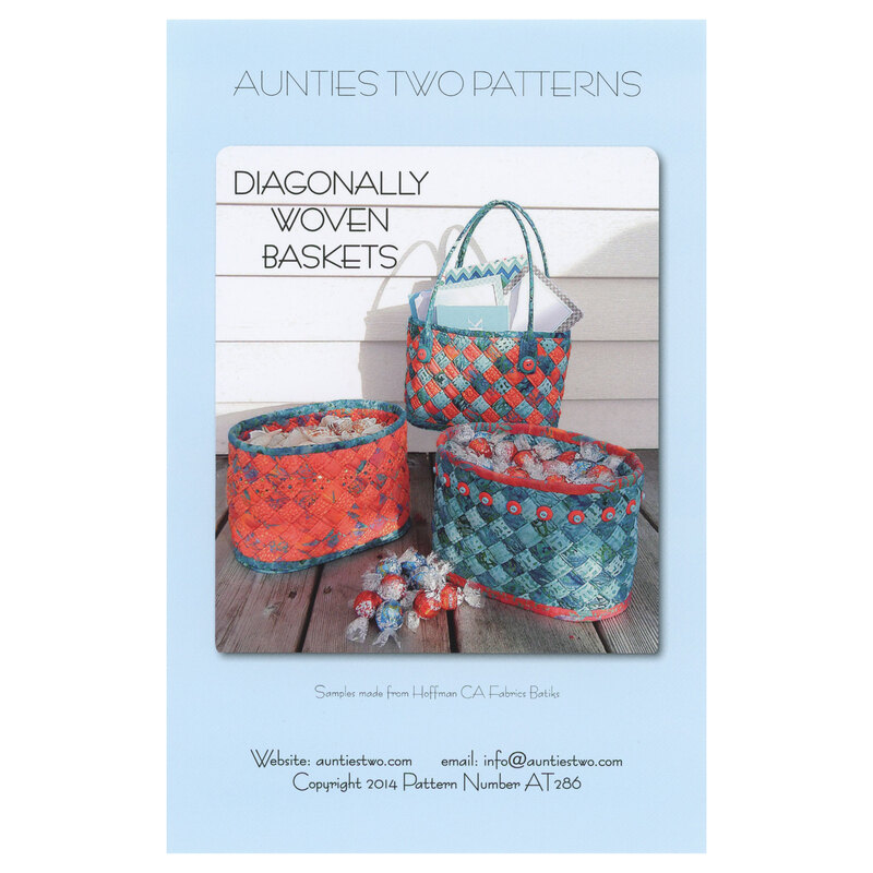Front Cover of Diagonally Woven Baskets pattern by Aunties Two Patterns featuring 3 finished baskets full of candy and mail displayed on a porch with candy laid out in front of them