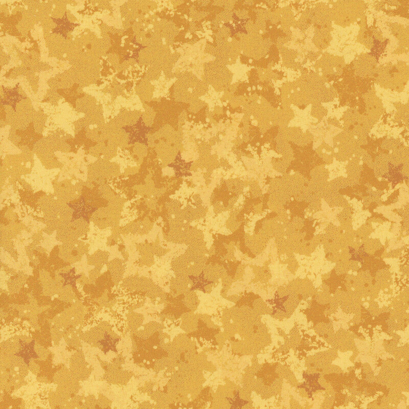 Swatch of golden yellow fabric with tossed and layered tonal gold stars.