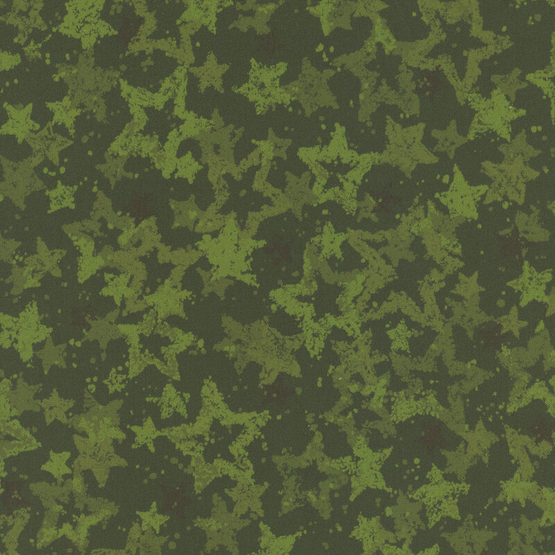 Swatch of evergreen fabric with tossed and layered tonal green stars.