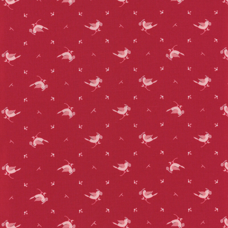 Red fabric with a pink bird and fruit design