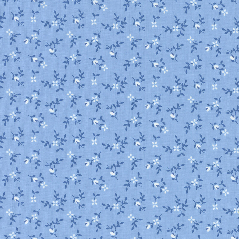 Tonal blue fabric with ditsy light blue flowers and dark blue sprigs throughout