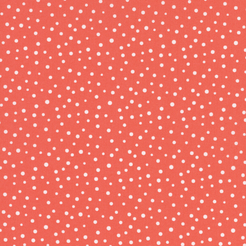 Bright pink fabric with small white polka dots of varying sizes throughout