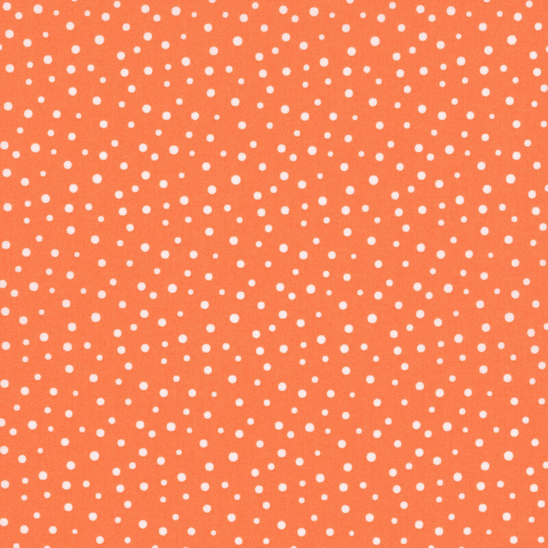 Bright orange fabric with small white polka dots of varying sizes throughout