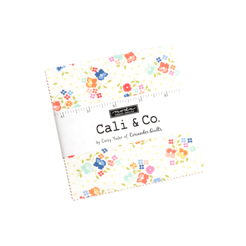A square stack of fabrics with a ruler label wrapped around it and a Moda - Cali & Co. logo