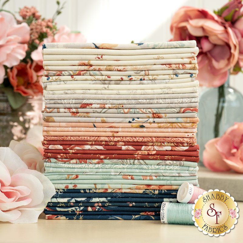 A photo of the fabrics in Sandalwood in shades of blue, aqua, cream, gray, red, and pink