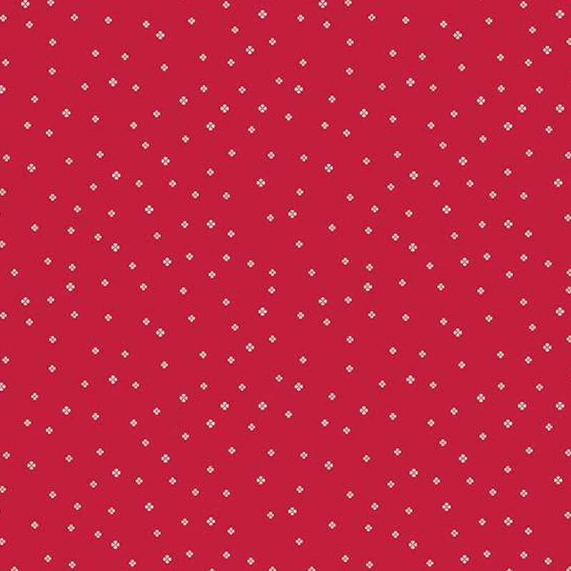 red fabric with tiny white simplified four-petaled flowers