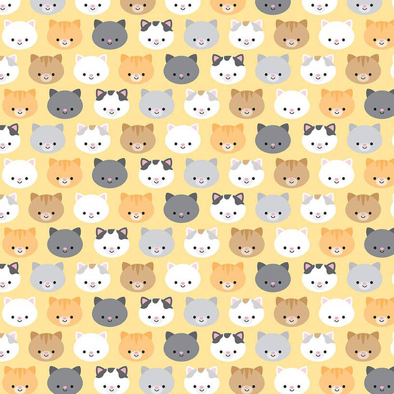 yellow fabric with colorful orange, black, gray, and white cat faces all over