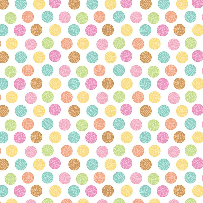 white sewing fabric with colorful balls of yarn polka dots all over