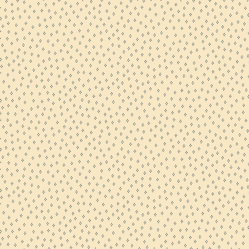 Cream fabric with a dancing dots pattern 