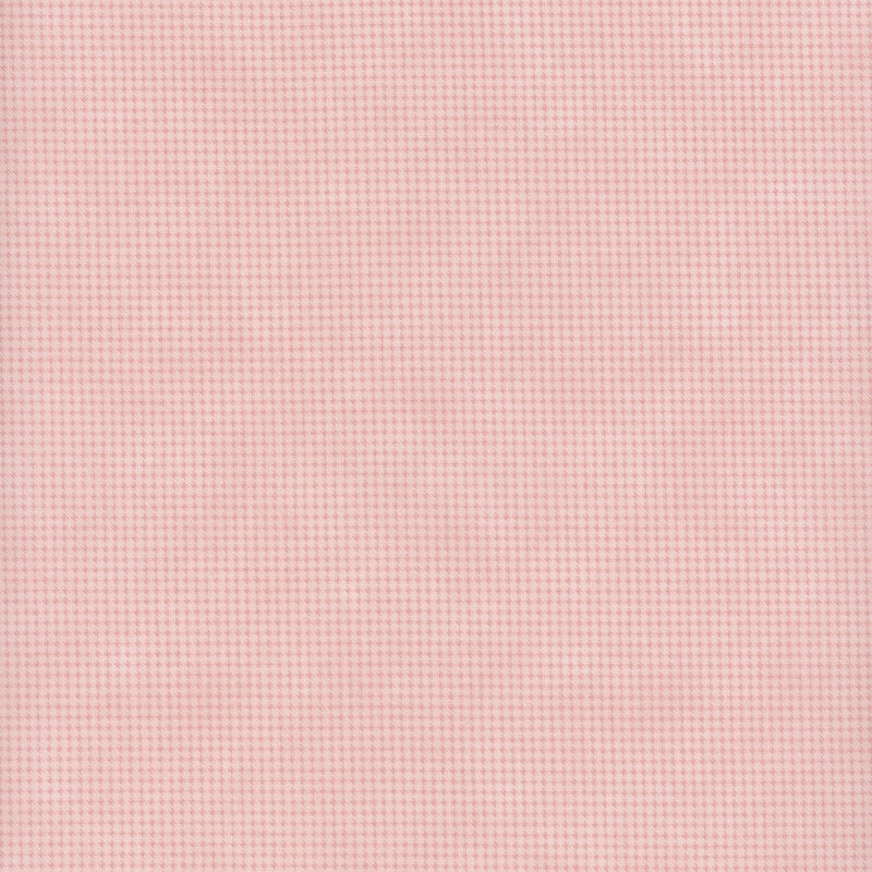 Mottled pale pink fabric with a small, repeating, dotted texture throughout