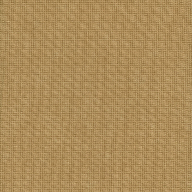 Mottled tan fabric with a small, repeating, dotted texture throughout