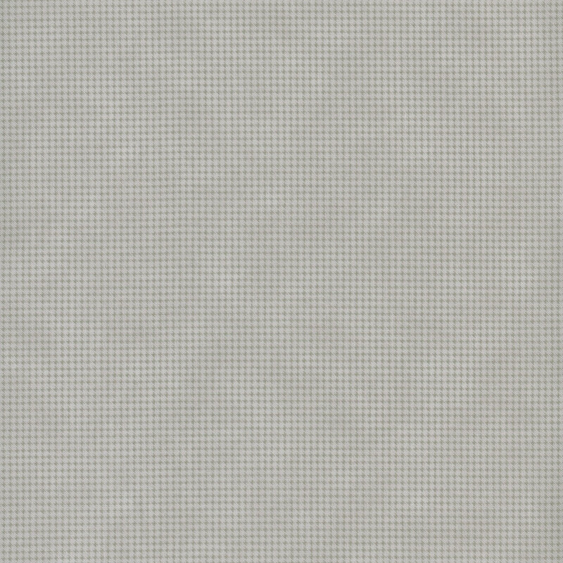 Mottled gray fabric with a small, repeating, dotted texture throughout