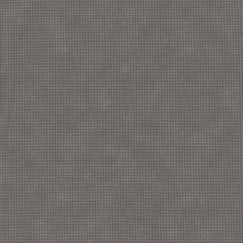Mottled dark gray fabric with a small, repeating, dotted texture throughout