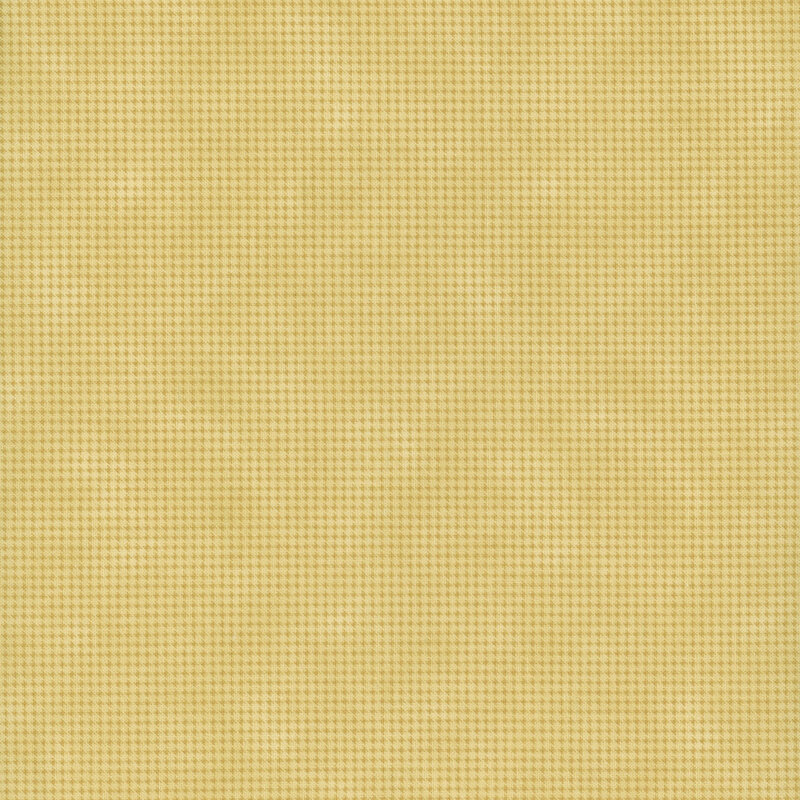 Mottled golden yellow fabric with a small, repeating, dotted texture throughout