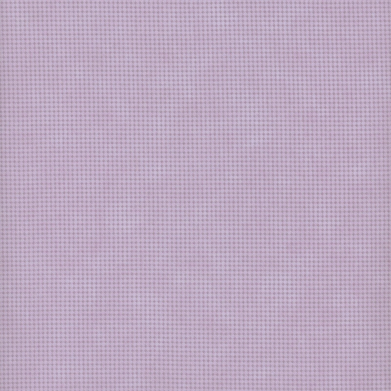 Mottled dusty purple fabric with a small, repeating, dotted texture throughout