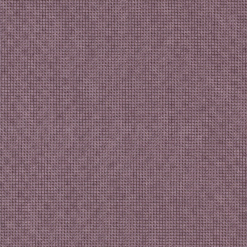 Mottled aubergine fabric with a small, repeating, dotted texture throughout