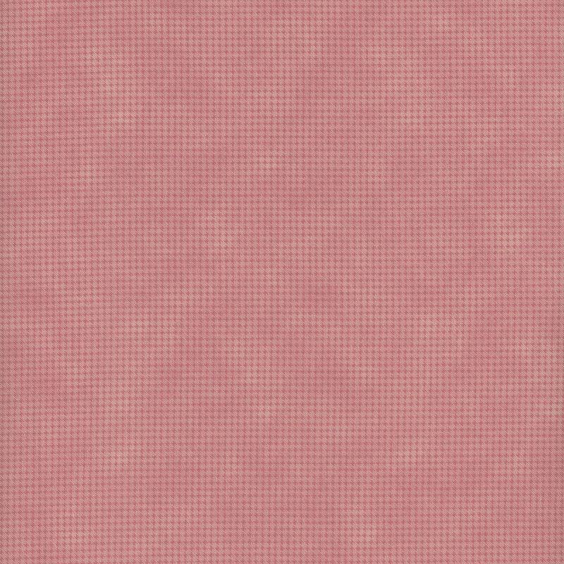Mottled dusty pink fabric with a small, repeating, dotted texture throughout